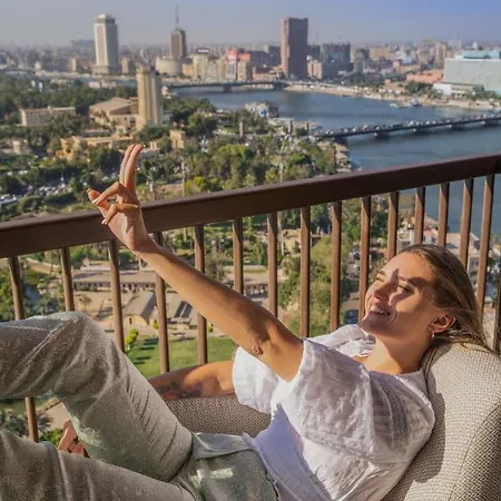 Sofitel Cairo Nile El Gezirah Hotel Giza Exterior photo A woman sunbathing on a balcony